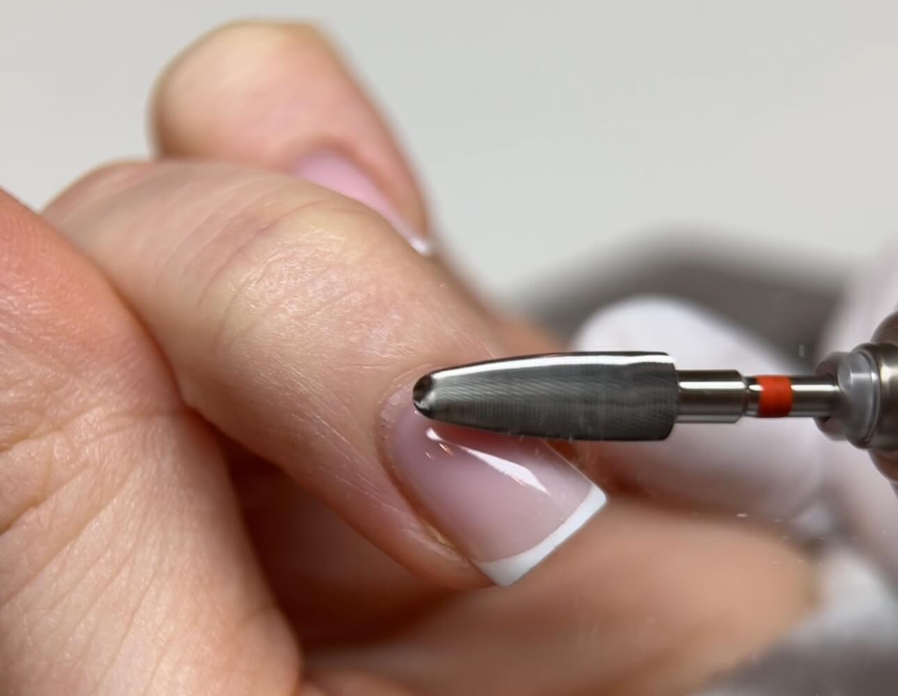 E-file smoothing near the cuticle during Russian Manicure for a clean and precise finish
