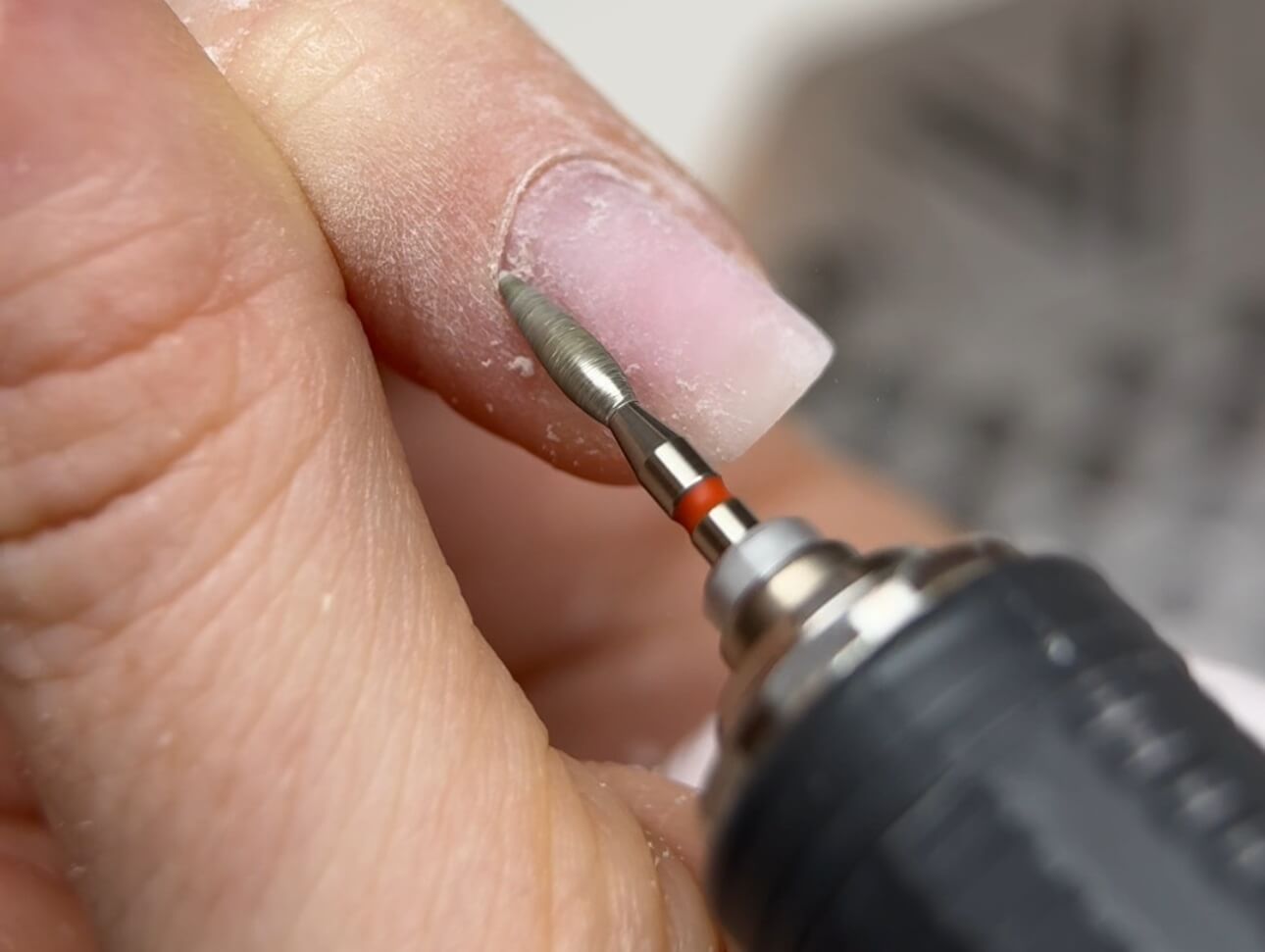 Deep e-file cleaning in the sidewalls during Russian Manicure to remove pterygium and prepare the cuticle pocket