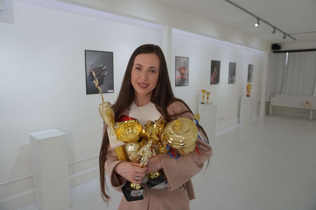 Vikki Swan international nail judge and educator holding competition awards